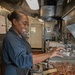 USS George H.W. Bush (CVN 77) Sailor Prepares Food