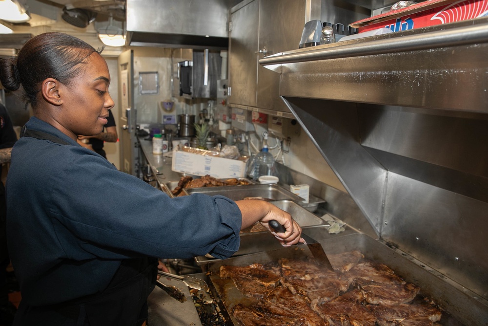 USS George H.W. Bush (CVN 77) Sailor Prepares Food