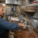 USS George H.W. Bush (CVN 77) Sailor Prepares Food