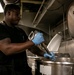 USS George H.W. Bush (CVN 77) Sailor Prepares Food