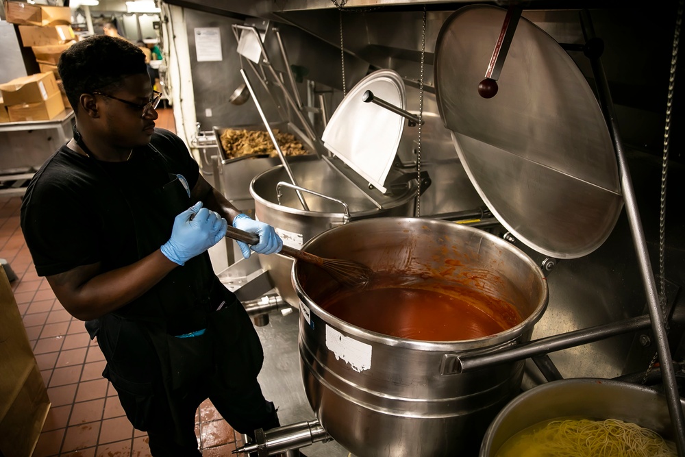 USS George H.W. Bush (CVN 77) Sailor Prepares Food