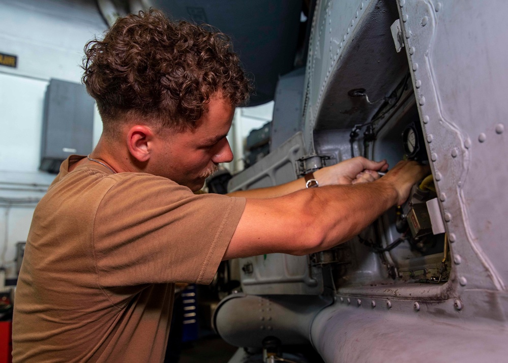 Helicopter Maritime Strike Squadron (HSM) 46 Sailor Conducts Maintenance on a MH-60R Sea Hawk Helicopter Aboard USS George H.W. Bush (CVN 77)