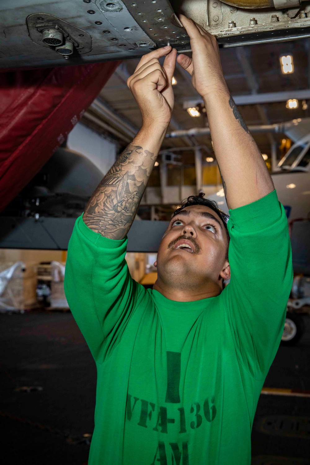 Strike Fighter Squadron (VFA) 136 Sailor Conducts Maintenance on a F/A-18E Super Hornet Aircraft Aboard USS George H.W. Bush (CVN 77)