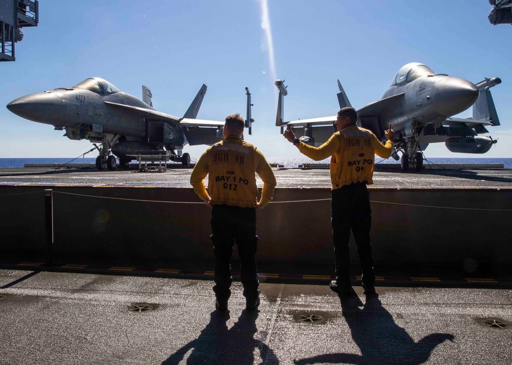 USS George H.W. Bush (CVN 77) Sailors Signal Elevator