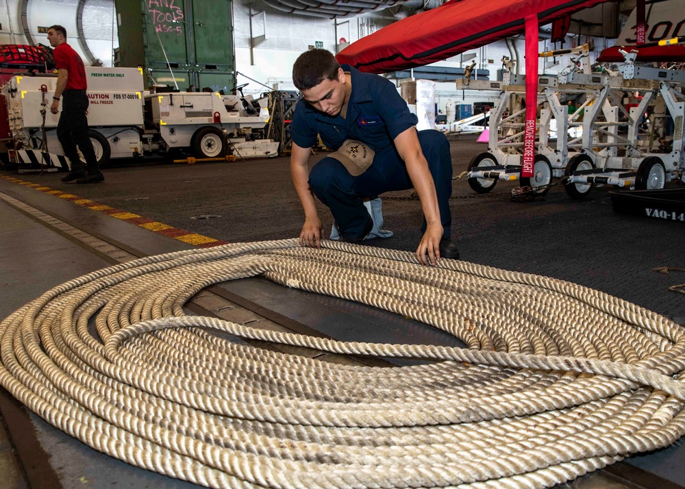 USS George H.W. Bush (CVN 77) Sailor Prepares Line for Storage