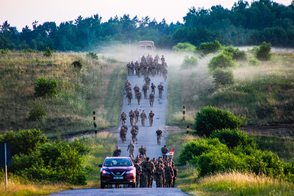 Spur Candidates Conduct a Ruck March During a Spur Ride