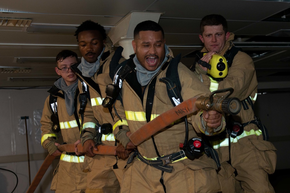 Sailors simulate fighting a fire