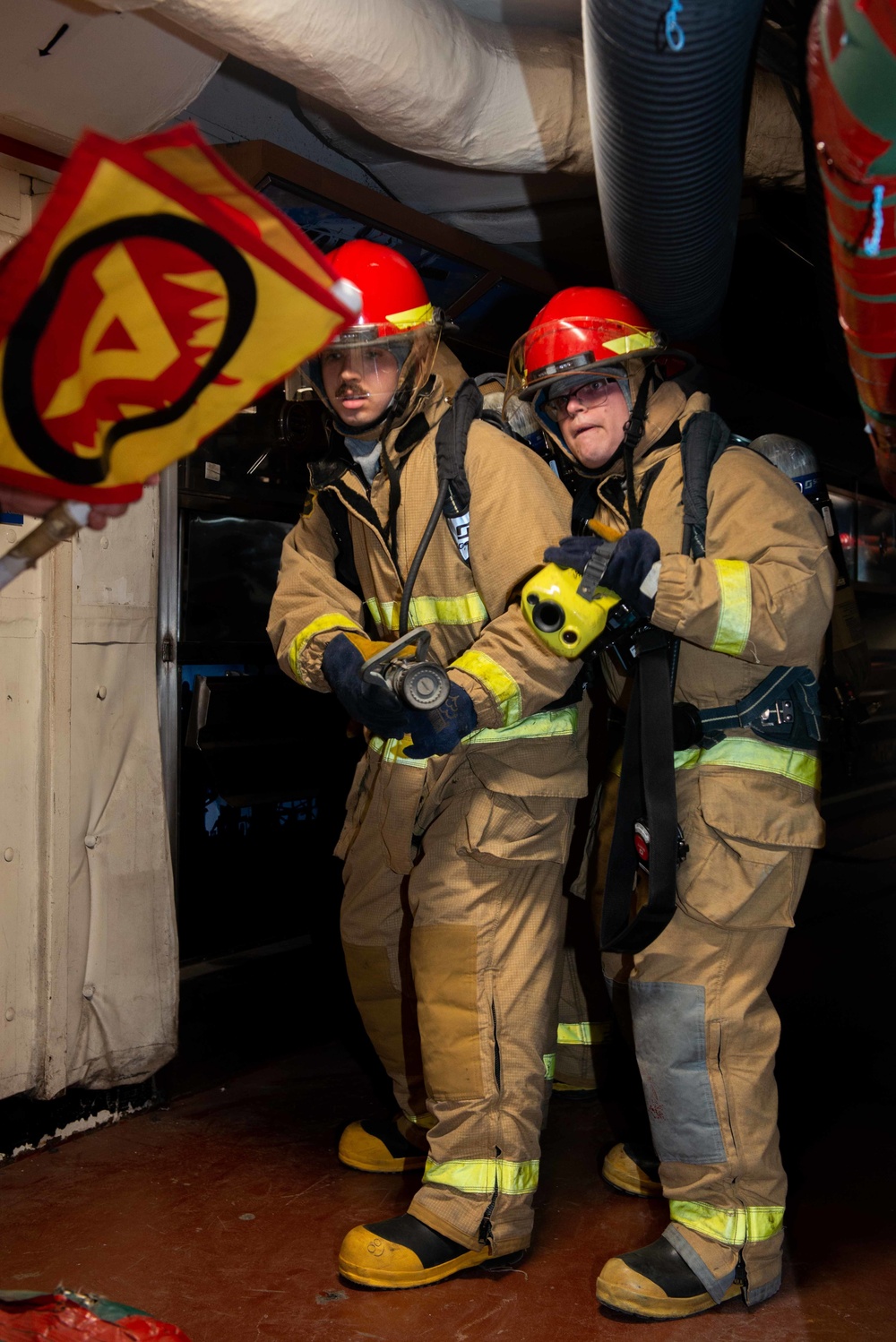 Sailors simulate fighting a fire