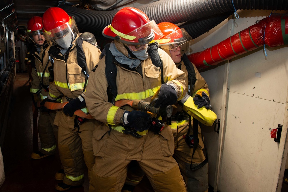 Sailors simulate fighting a fire