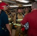 Sailors debrief after a damage control drill