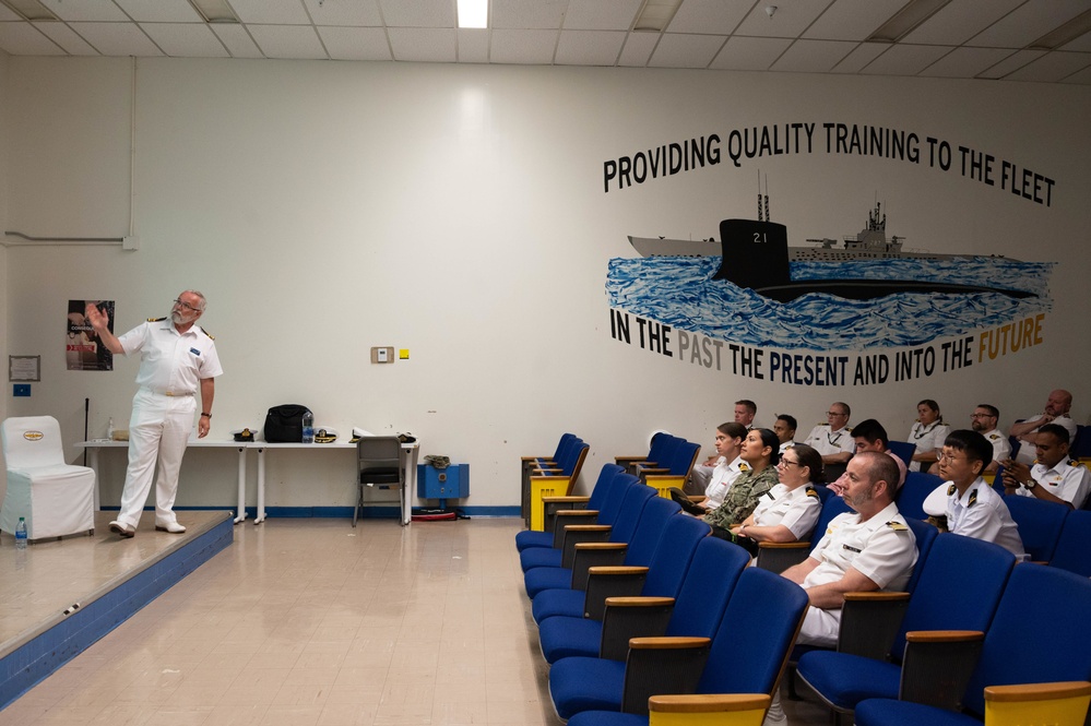 Military members from multiple nations participate in a NCAGS symposium during RIMPAC 2022