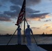 Sailors from Abraham Lincoln lower the national ensign during RIMPAC 2022