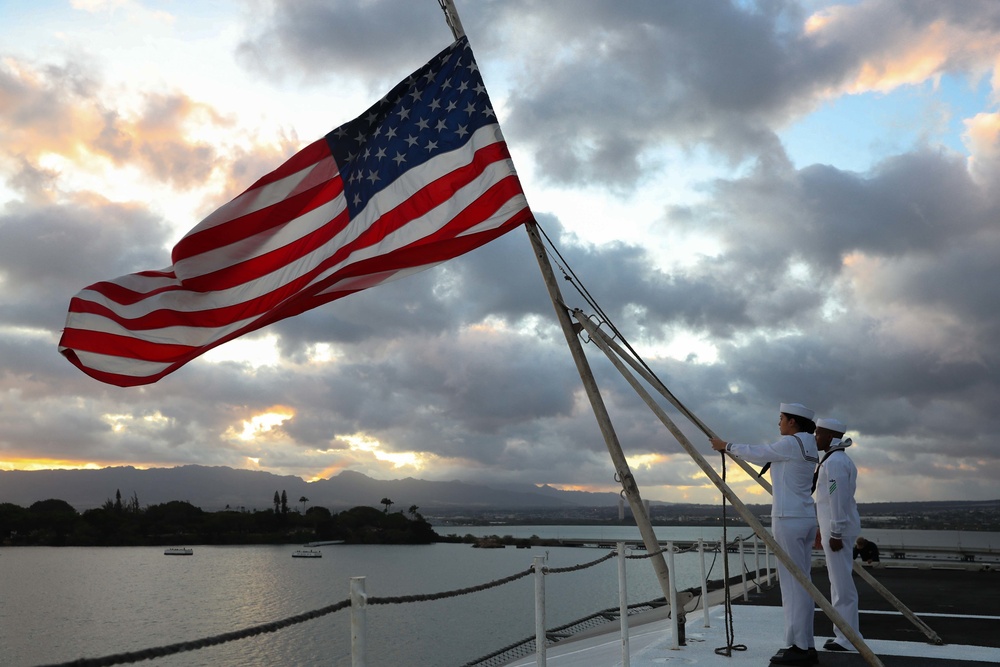Sailors from Abraham Lincoln lower the national ensign during RIMPAC 2022