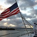 Sailors from Abraham Lincoln lower the national ensign during RIMPAC 2022