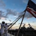 Sailors from Abraham Lincoln lower the national ensign during RIMPAC 2022