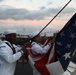 Sailors from Abraham Lincoln lower the national ensign during RIMPAC 2022