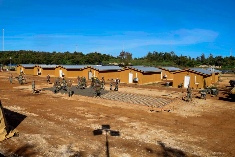 NMCB THREE Seabees and 7th ESB Marines place a concrete pad on Camp Tinian.