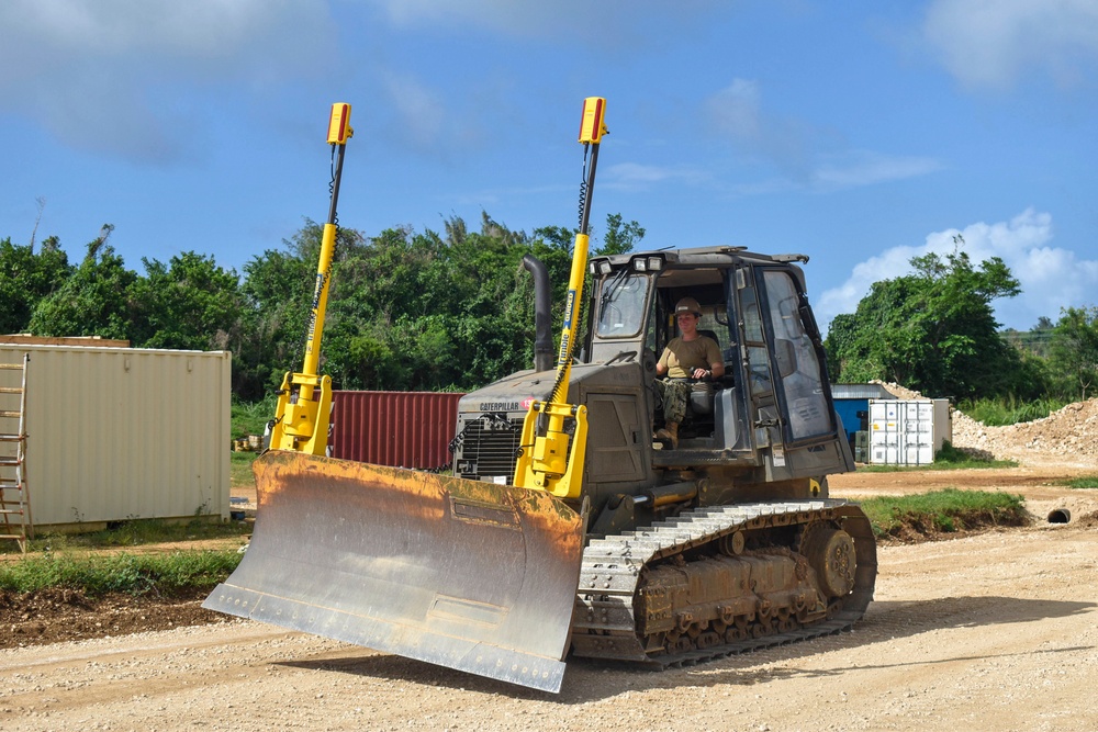 NMCB THREE Seabees conduct operations check on dozer after installing tremble earthworms system.