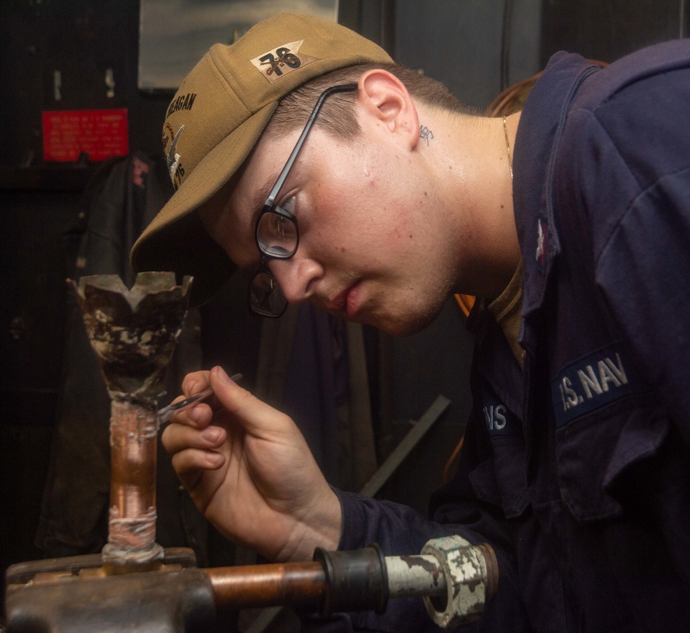USS Ronald Reagan (CVN 76) Sailors braze pipes in the machine shop