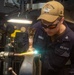 USS Ronald Reagan (CVN 76) Sailors braze pipes in the machine shop