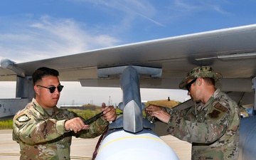 Airmen from AATC load a JASSM on pre-block F-16