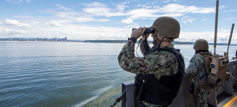 Sailors Stand Watch As USS Nimitz Gets Underway