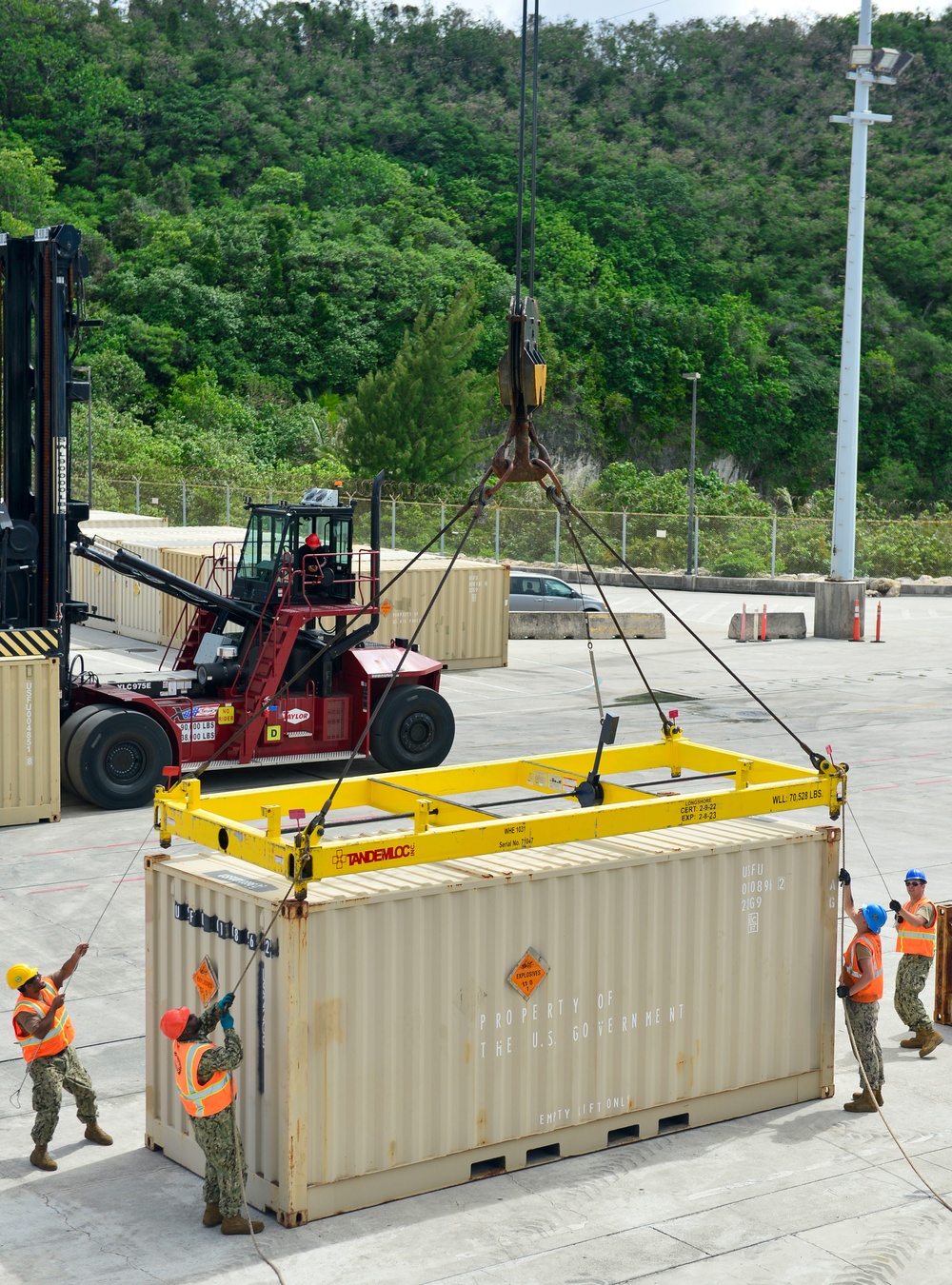 Sailors provide cargo handling and transportation services of ammo ISO containers aboard MV Ocean Glory