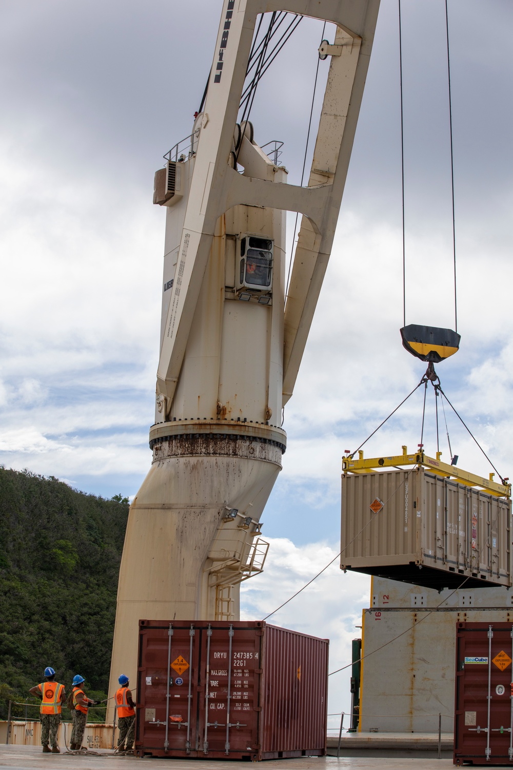 Sailors provide cargo handling and transportation services of ammo ISO containers aboard MV Ocean Glory