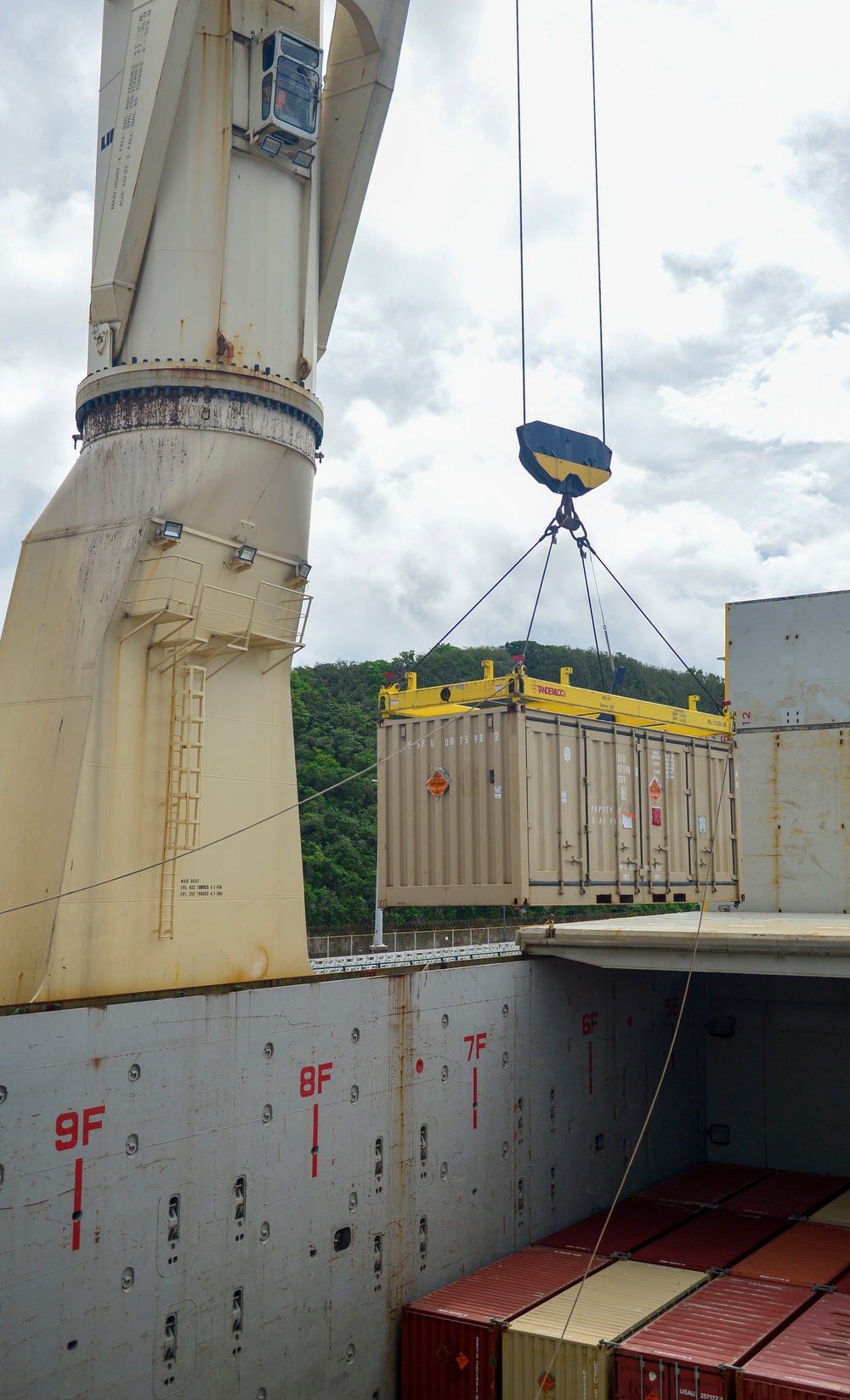 Sailors provide cargo handling and transportation services of ammo ISO containers aboard MV Ocean Glory