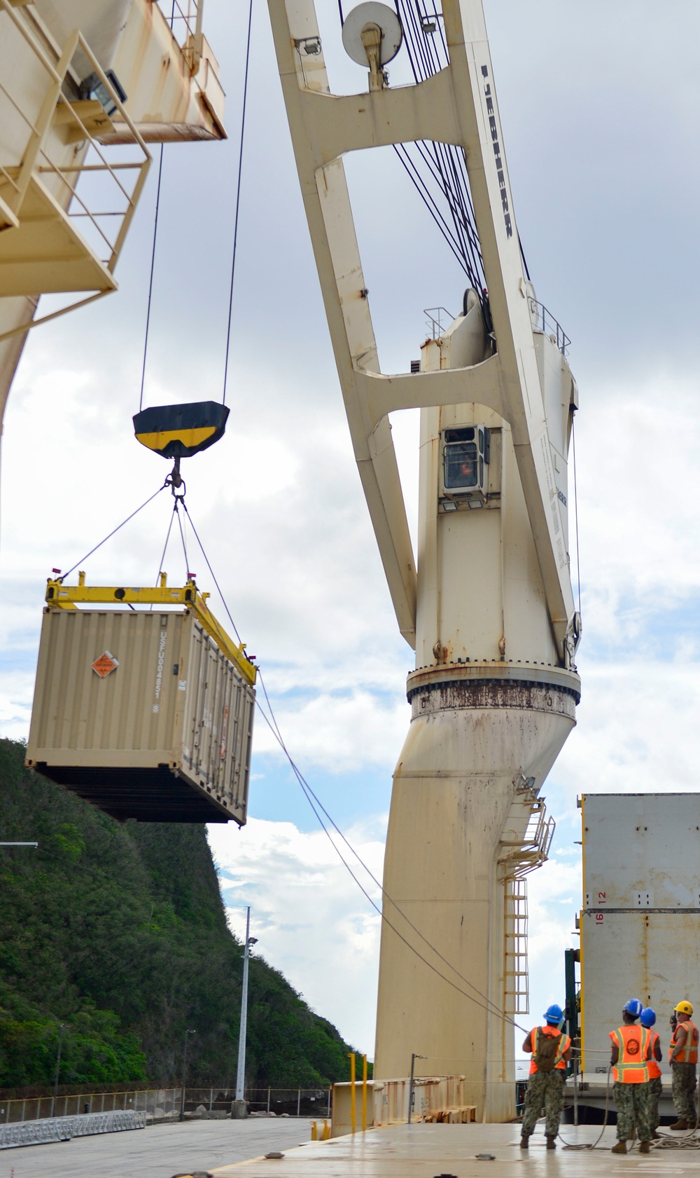 Sailors provide cargo handling and transportation services of ammo ISO containers aboard MV Ocean Glory