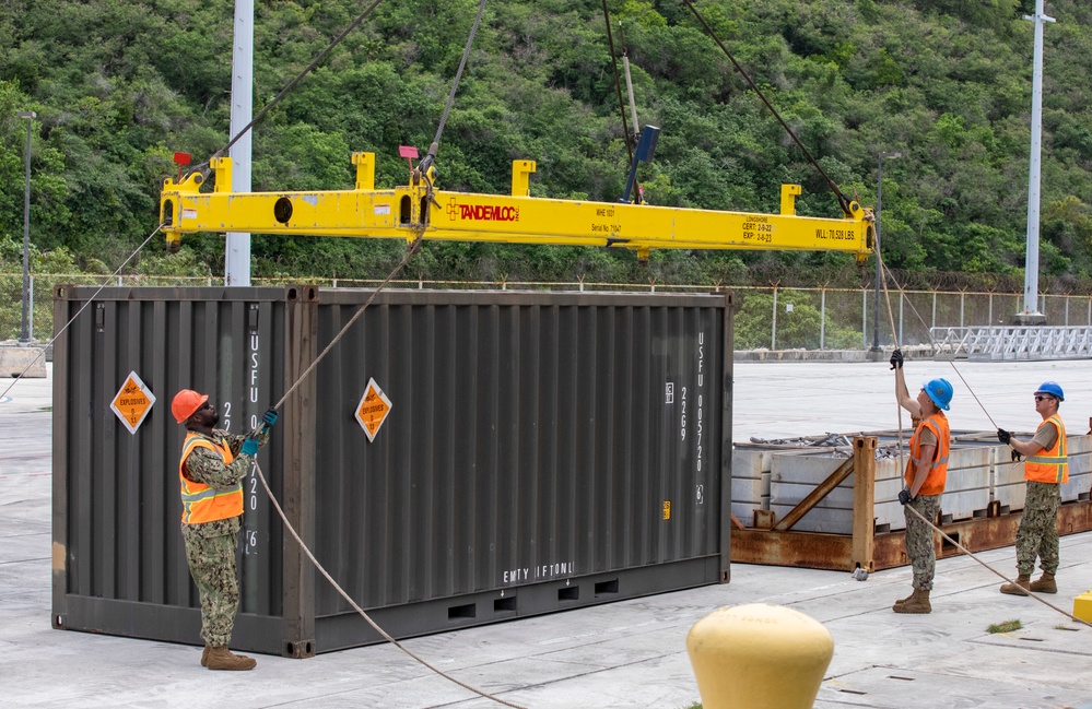 Sailors provide cargo handling and transportation services of ammo ISO containers aboard MV Ocean Glory