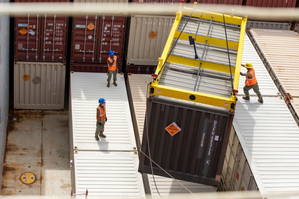 Sailors provide cargo handling and transportation services of ammo ISO containers aboard MV Ocean Glory