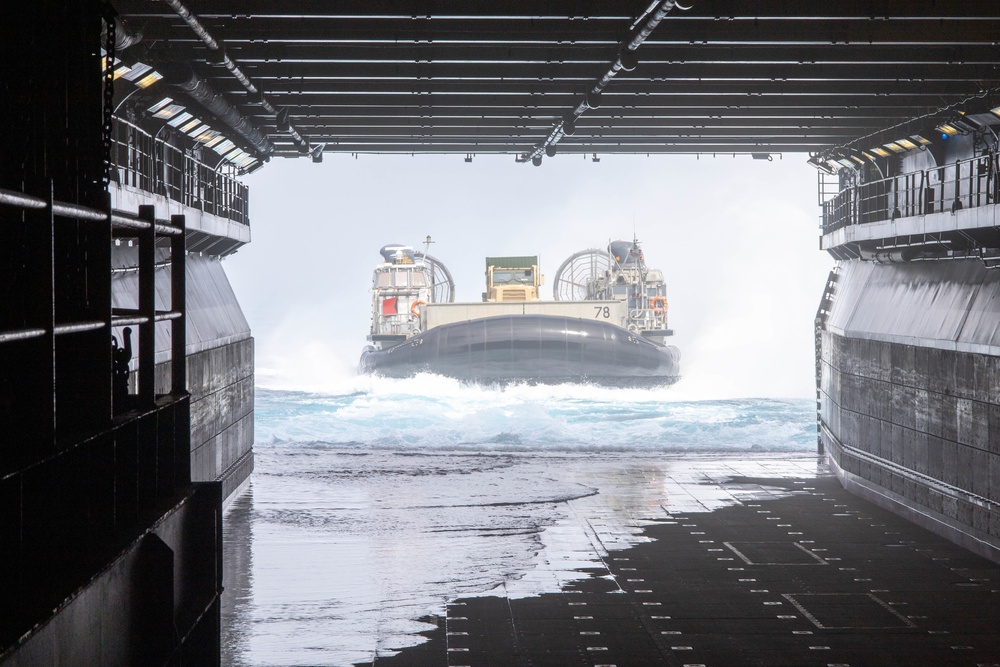 Marines onload equipment to the USS Makin Island with LCACs