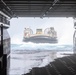 Marines onload equipment to the USS Makin Island with LCACs