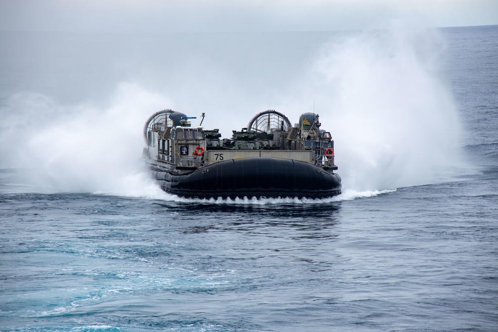 Marines onload equipment to the USS Makin Island with LCACs