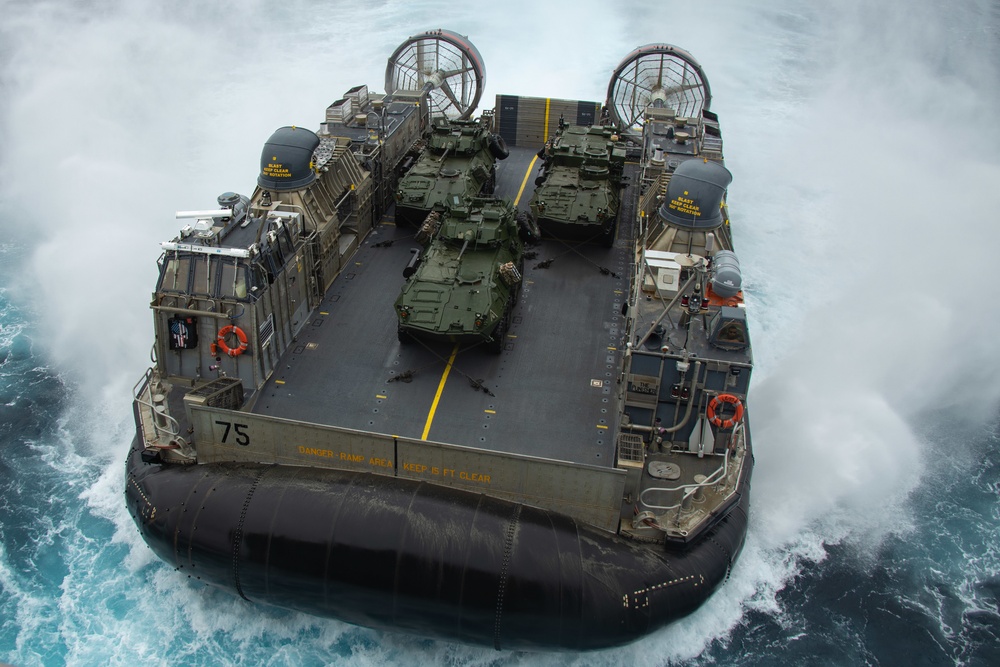 Marines onload equipment to the USS Makin Island with LCACs