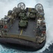 Marines onload equipment to the USS Makin Island with LCACs