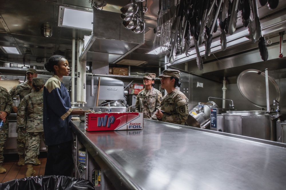 Col. Elba Villacorta and Sgt. Elizabeth Currie discuss RIMPAC food safety and preparation procedures with members of the U.S. Navy aboard the USS Hopper (DDG 70)