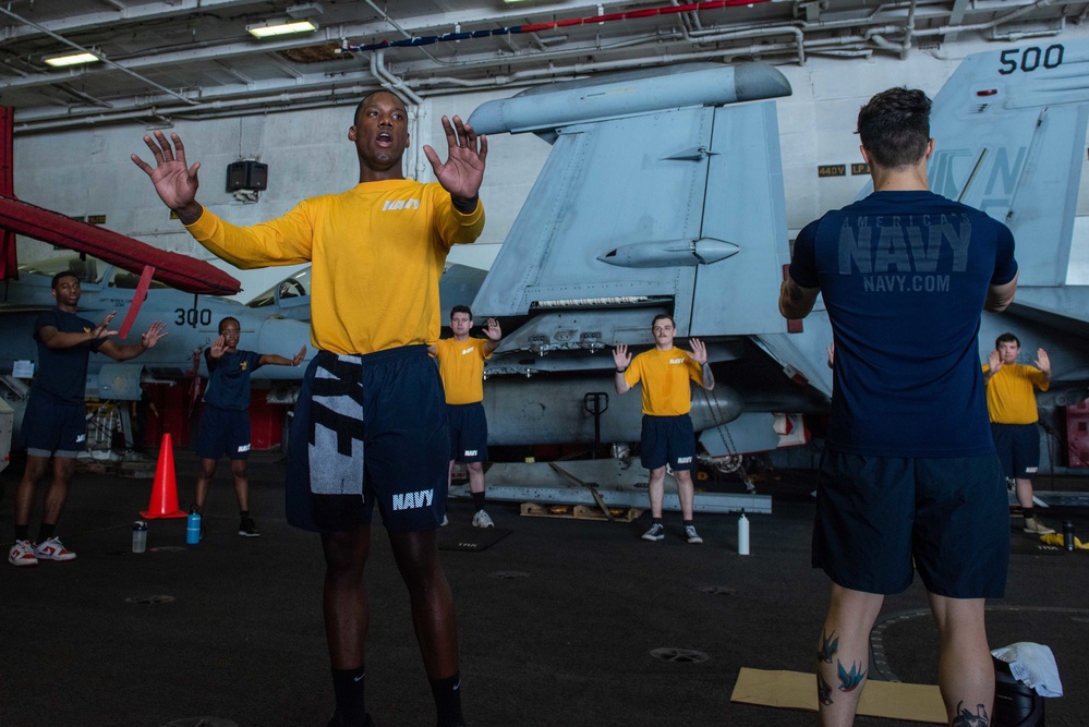 USS Ronald Reagan (CVN-76) Sailors perform physical training