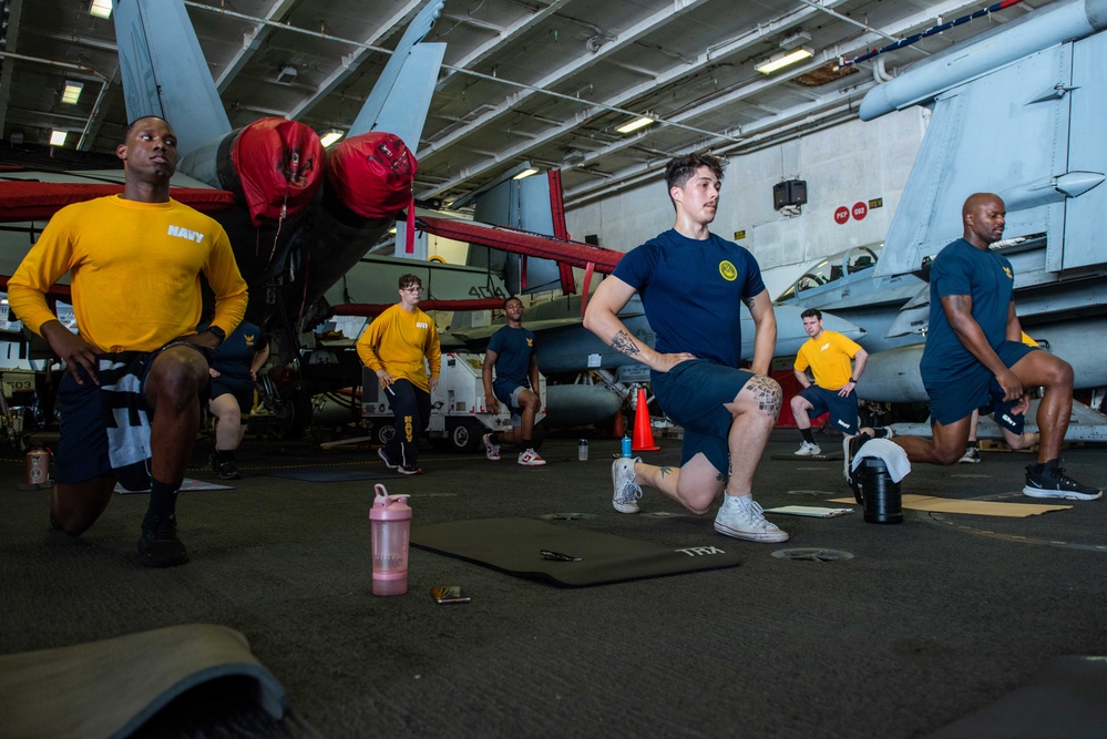 USS Ronald Reagan (CVN-76) Sailors perform physical training