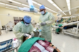 Dental students practice their skills while treating Soldiers, dependents, and retirees