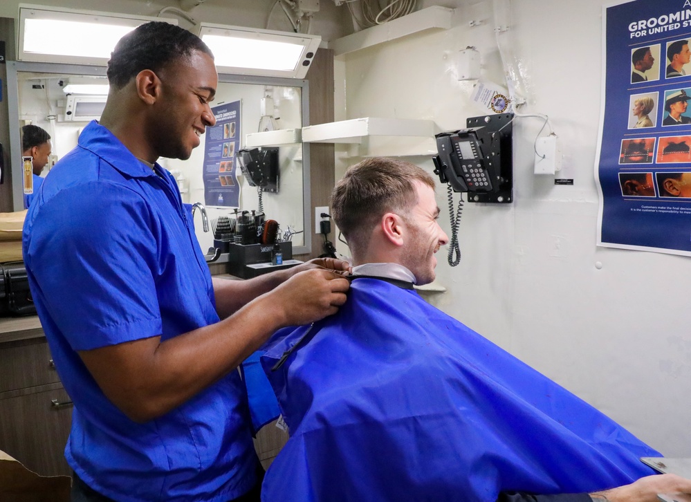 Sailor Assigned to USS Truxtun (DDG 103) Cuts Hair in the Ship's Barbershop