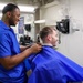 Sailor Assigned to USS Truxtun (DDG 103) Cuts Hair in the Ship's Barbershop