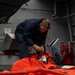 Boatswain’s Mates prepare lifejackets on USS Anchorage