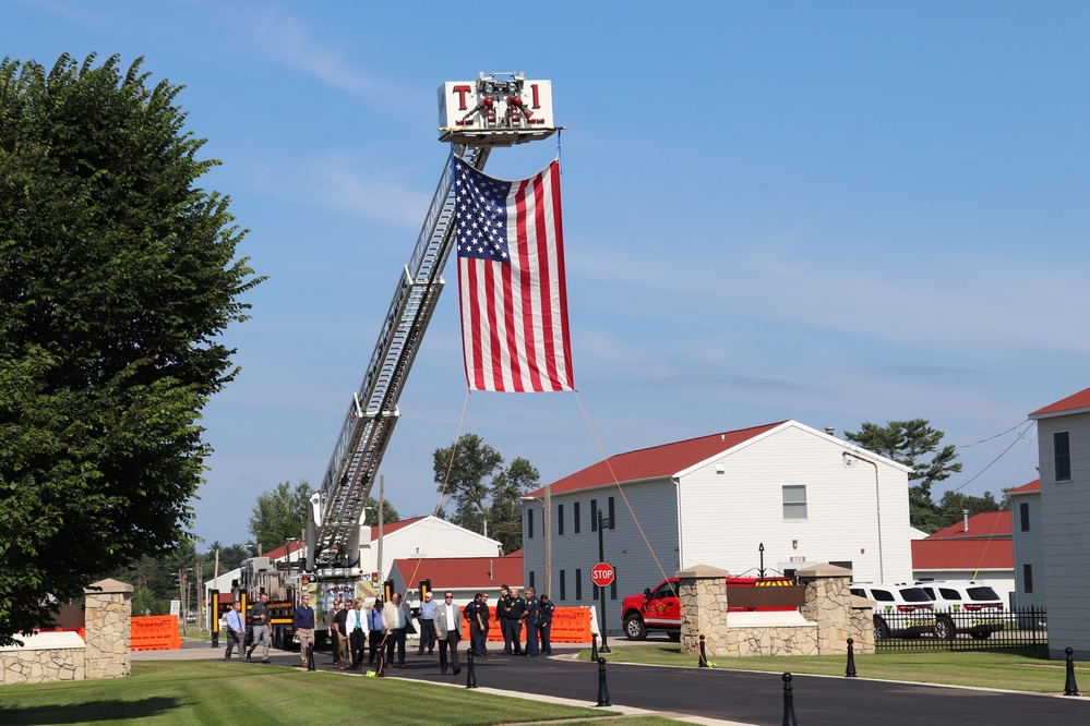 Firefighters and the American flag for Fort McCoy Garrison Change of Command ceremony
