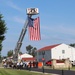 Firefighters and the American flag for Fort McCoy Garrison Change of Command ceremony