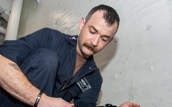 USS Ronald Reagan (CVN 76) Sailor conducts air flow monitoring