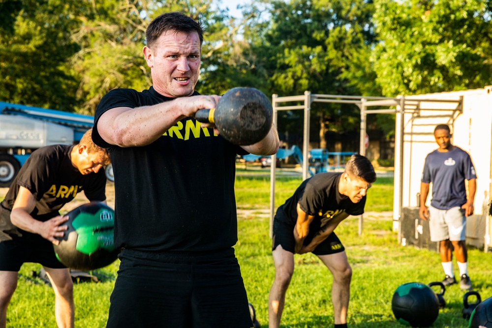 Maj. Gen. Brian Mennes does PT with Data Warfare Company Innovation Cadets