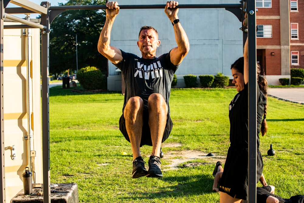 Maj. Gen. Brian Mennes does PT with Data Warfare Company Innovation Cadets