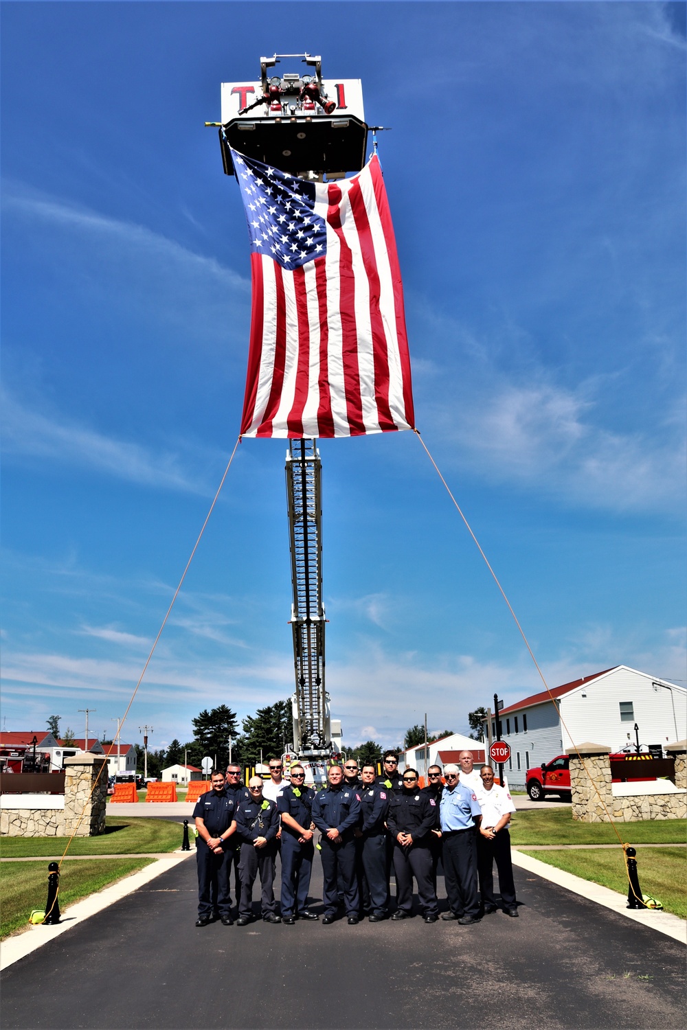 Firefighters and the American flag for Fort McCoy Garrison Change of Command ceremony